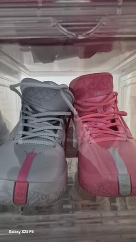Customer's Joker 1 'Reverse' basketball shoes inside a clear shoebox, showing the mismatched white and pink design.