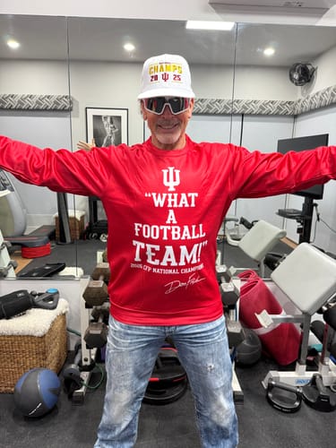 Reviewer showing the front of a red custom pullover hoodie with the text "WHAT A FOOTBALL TEAM!"