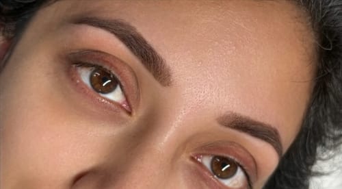 Close-up of a customer's defined, dark eyebrows after an application of Oak - Hybrid Brow Stain.