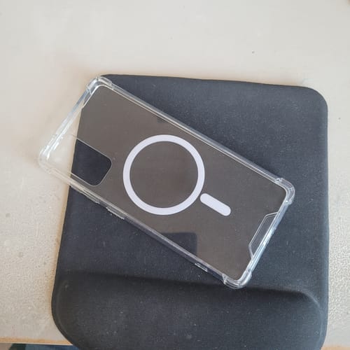 Customer's MagCase Clear phone case with its white MagSafe ring, shown on a black mousepad.