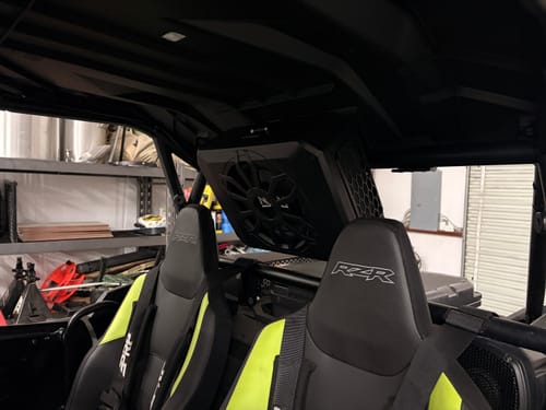Customer's black NSUB.3 speaker mounted to the roof of a UTV, positioned between the two front seats.