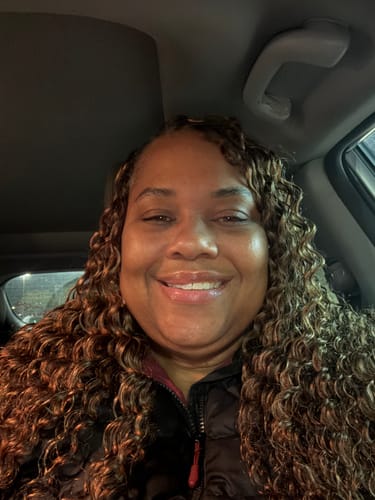 Customer smiling, showing off their voluminous, multi-toned Deep Wave Human Crochet Hair in a car.
