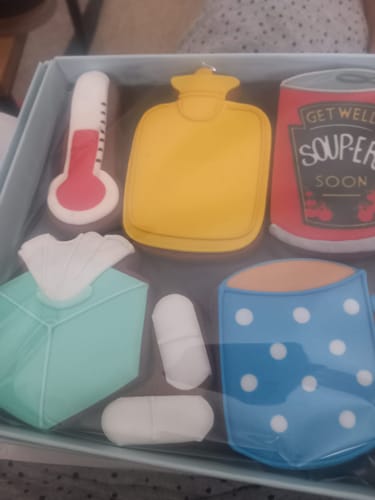 Customer's Get Well Soup-er Soon Biscuit Box in its packaging, showing colorful biscuits shaped like a soup can, mug, and thermometer.
