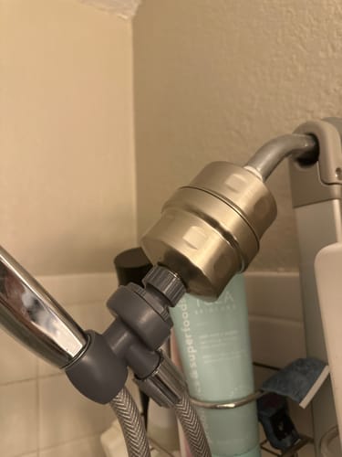 Customer's sturdy Shower Head Filter installed between the shower arm and hose.