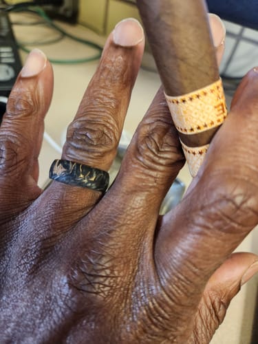Close-up of a reviewer's hand wearing the marbled black Grand Prix ring.