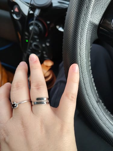 Customer showing their silver Just Breathe Ring on their finger while inside a car.