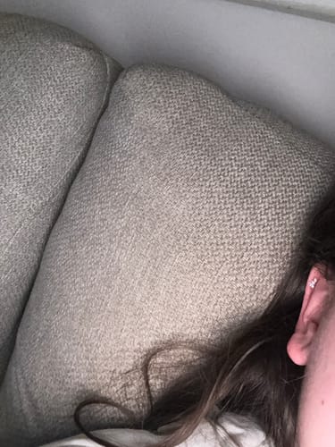 Close-up of a reviewer's ear showing the sparkly Winged Crystal Flatback Stud in a cartilage piercing.