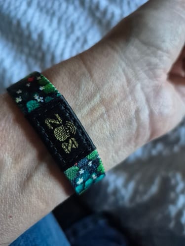 Reviewer wearing the Lucky You Bracelet on their wrist, showing the special Pot O Gold stitching.