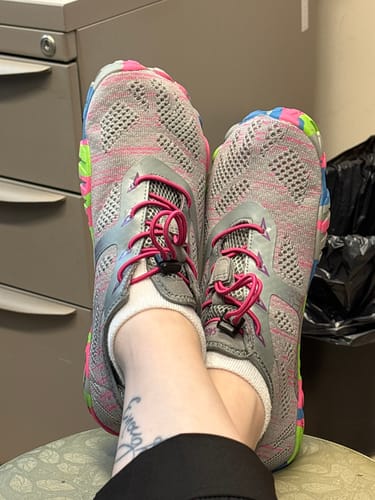Customer relaxing with their feet up, wearing the colorful Smart II - Barefoot Shoes.