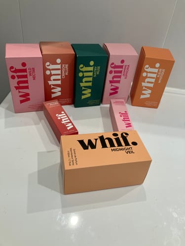 Customer's peach box of Midnight Veil fragrance displayed with their collection of other colorful Whif perfume boxes.