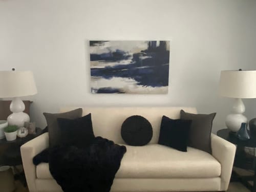 Customer's 'Abstract Navy Blue' canvas hanging on a wall above a white sofa in a living room.