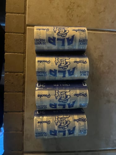 Customer's four sleeves of Chilled Mint Nicotine Pouches stacked horizontally on a tiled surface.