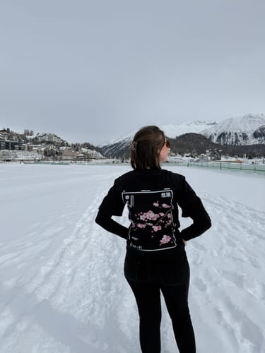 Reviewer from behind wearing the black Cherry Blossom T-Shirt in a snowy landscape.