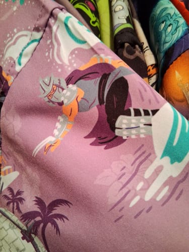 Reviewer's close-up of the lavender 'Shredder Shreds' shirt, showing the Shredder character surfing on a wave.