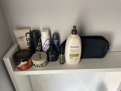 Customer's Curl Gel jar sitting on a white shelf among other personal care products.