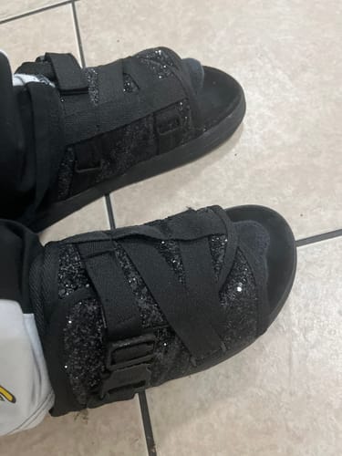 Customer wearing the black SuperStar DracoSlides, showing the sparkly rhinestone design on the upper straps.
