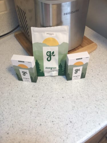 Customer's Royal Cherry Pre-Rolls in their 'cleangreen' packaging on a kitchen counter.