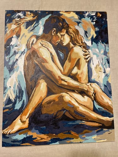 Reviewer's finished Sensual Lovers paint-by-number artwork, showing a nude couple in an intimate embrace against a blue background.