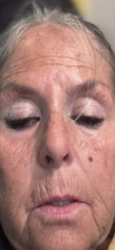 Close-up of a reviewer's face, showing the effect of the Grass Fed Tallow & Honey Balm on her skin.