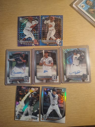 Customer's collection of valuable baseball cards protected in clear Basic Top Loaders on a table.