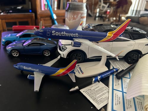 Customer's two Skymarks Flight Southwest 737-800 models displayed on a desk with other model cars.