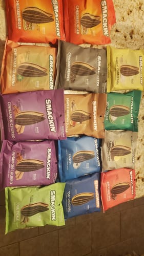 Customer's VARIETY PACK of sunflower seeds with many colorful bags spread out on a counter.
