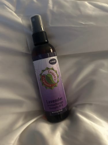 Customer's Lavender Aromatherapy Mist spray bottle resting on a white pillow.
