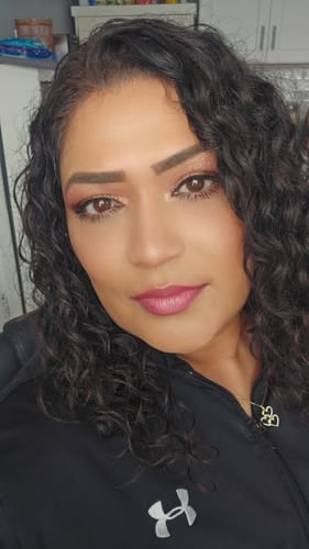 Customer with defined, bouncy curls after using the Curl Cream.