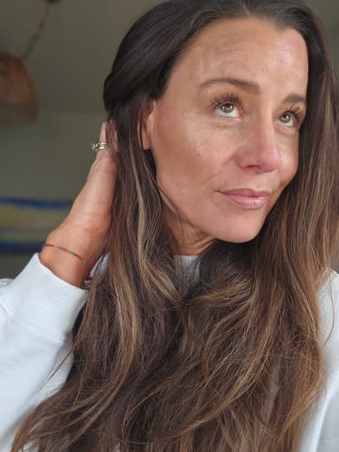 Reviewer's glowing face showing smoother skin after using the Seranova Micro Infusion System.