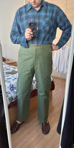 Reviewer taking a mirror photo to show the full-length fit of the olive 1944 USMC Officer Trousers.