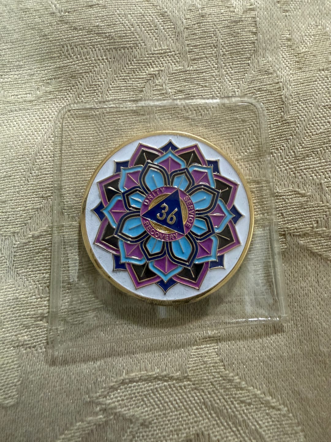 Customer photo review of 36 Year Sobriety Mint 'In Bloom' Lotus Flower Gold Plated AA Recovery Medallion - Thirty-Six Year Chip/Coin - White