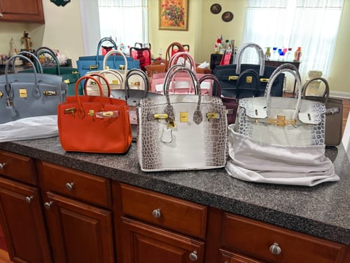 Customer's large collection of Warkin Bags in various colors and textures displayed on a kitchen counter.