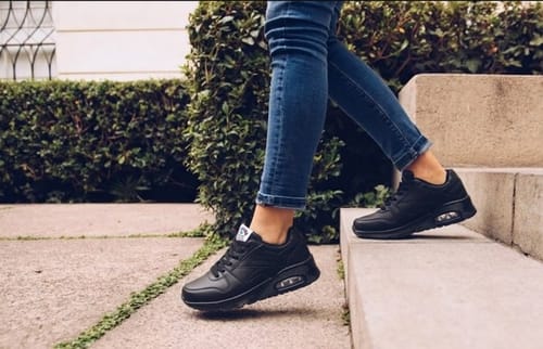 Reviewer walking down outdoor steps wearing black Bliss Walk shoes.