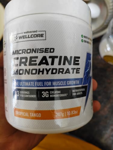 Reviewer's white container of Wellcore Micronised Creatine Monohydrate, showing the Tropical Tango flavor label.