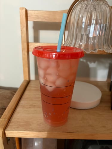 Customer's Migranium drink prepared with ice in a tumbler with a red lid and blue straw.