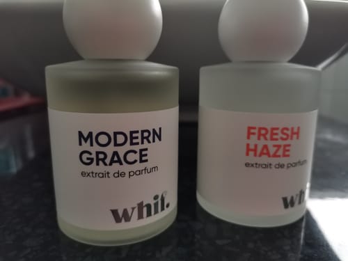 Customer's bottle of Modern Grace perfume sitting next to their Fresh Haze perfume bottle.
