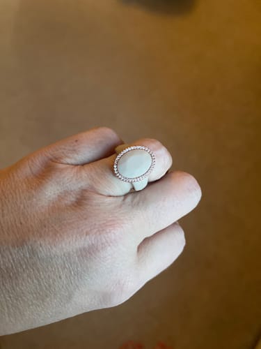 Customer's hand wearing the stylish Oversize Oval Silicone Ring with its large, stone-rimmed oval setting.