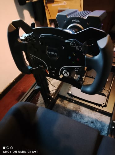 Customer's MOZA ESX Steering Wheel installed on a black sim racing rig.