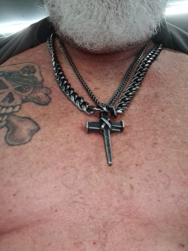 Close-up of a reviewer wearing the thick Knights Templar Cuban Link Necklace, layered with other chains.