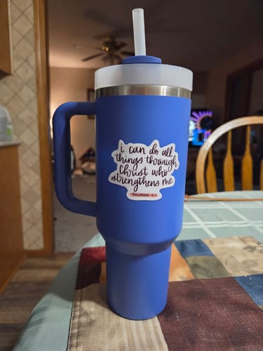 Customer's faith sticker applied to a large blue tumbler with a handle.