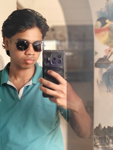 Reviewer taking a mirror selfie wearing the geometric black Cubix sunglasses.