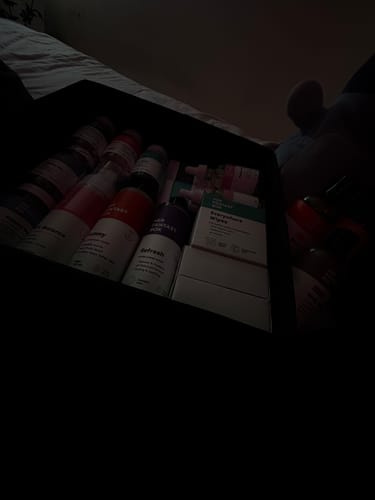 Partial view of a customer's Everything Bundle products neatly arranged in a box in a dimly-lit room.