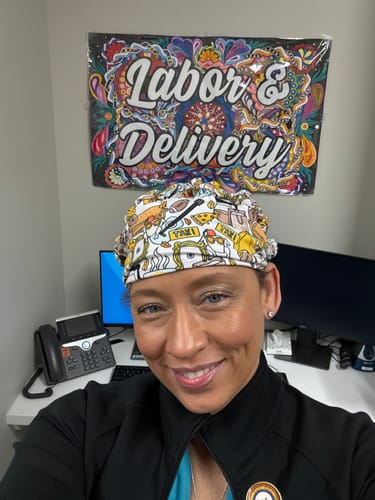 Customer at a desk wearing the comfortable DuoStyle Scrub Hat with a colorful Friends pattern.