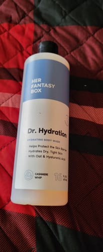 Customer's 16oz bottle of Dr. Hydration body wash resting on a red and black quilted surface.