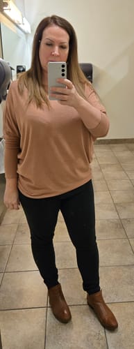 Reviewer showing the relaxed fit of the Jolie All Day Slouch Top in butterscotch, paired with black pants and brown ankle boots.