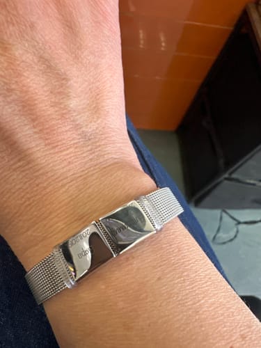 Customer showing the engraved stainless steel Lux bracelet on their wrist.