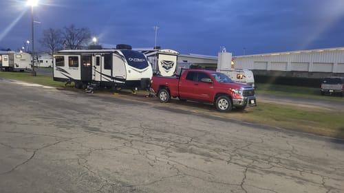 Customer's red Toyota Tundra towing a large travel trailer, appearing level with the HD Kit installed.