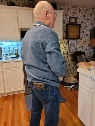 A reviewer for the T.V.P. Elite Membership standing in their kitchen.