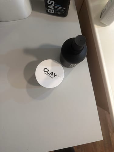 Customer's Texture & Hold Duo products, the clay and sea salt spray, sitting on a white bathroom counter.