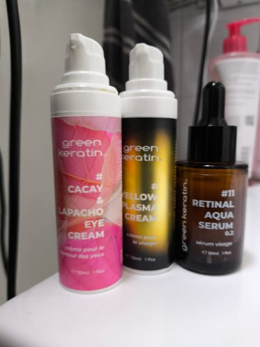 Photo d'un client montrant le sérum #11 Retinal Aqua avec deux autres produits de soin sur une étagère de salle de bain.